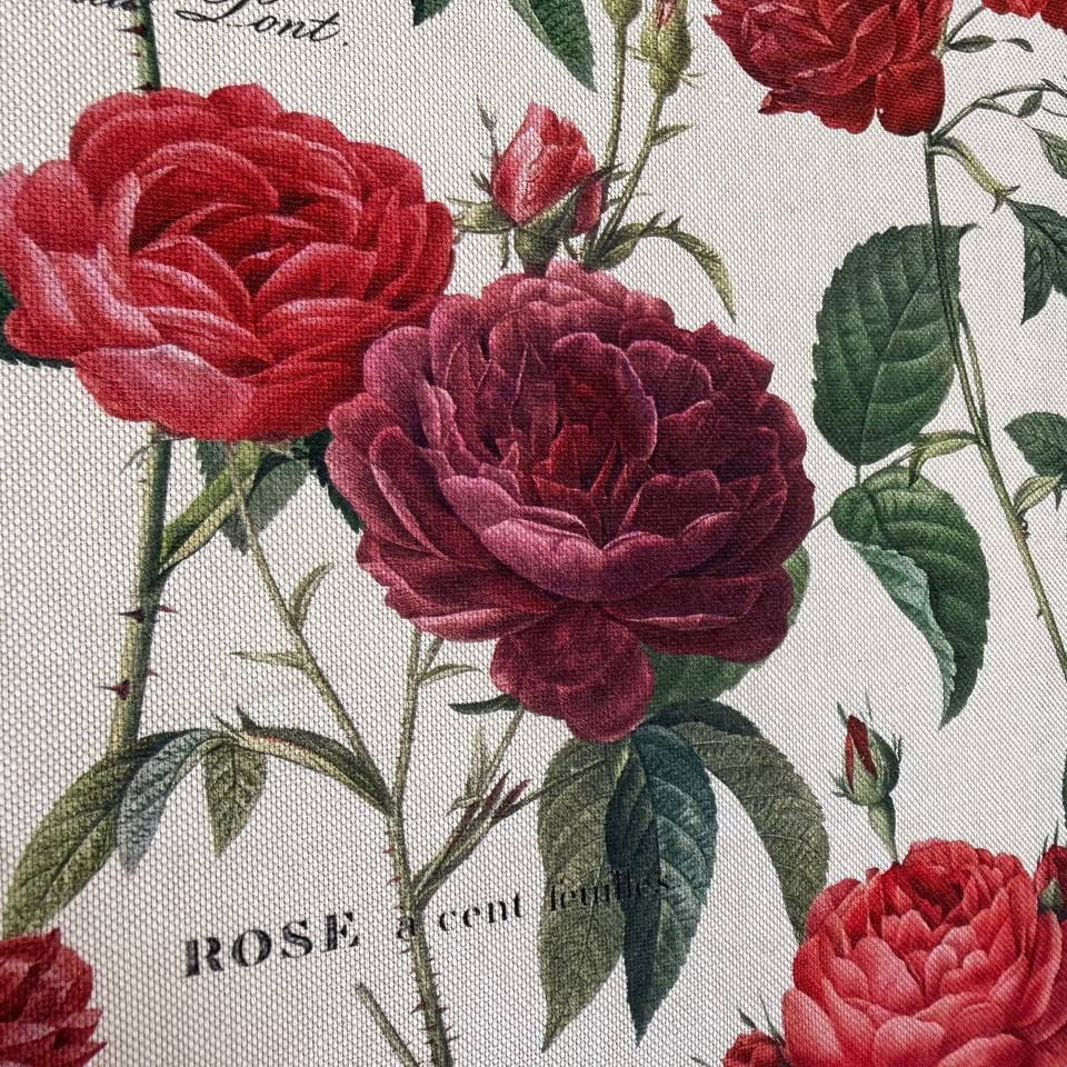 Elegant cotton fabric featuring a beautiful vintage botanical rose print on a soft ivory background.