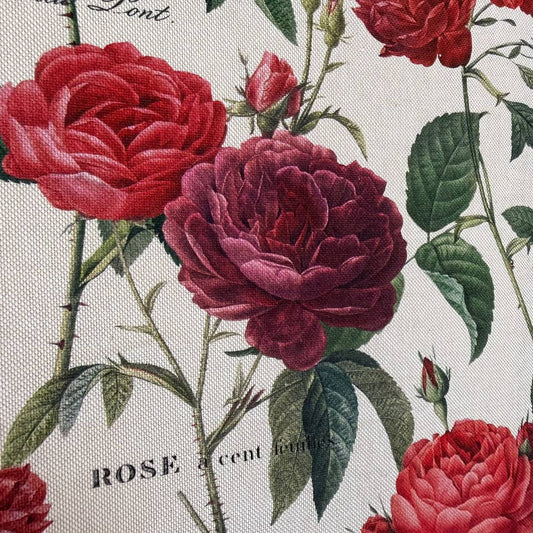 Elegant cotton fabric featuring a beautiful vintage botanical rose print on a soft ivory background.