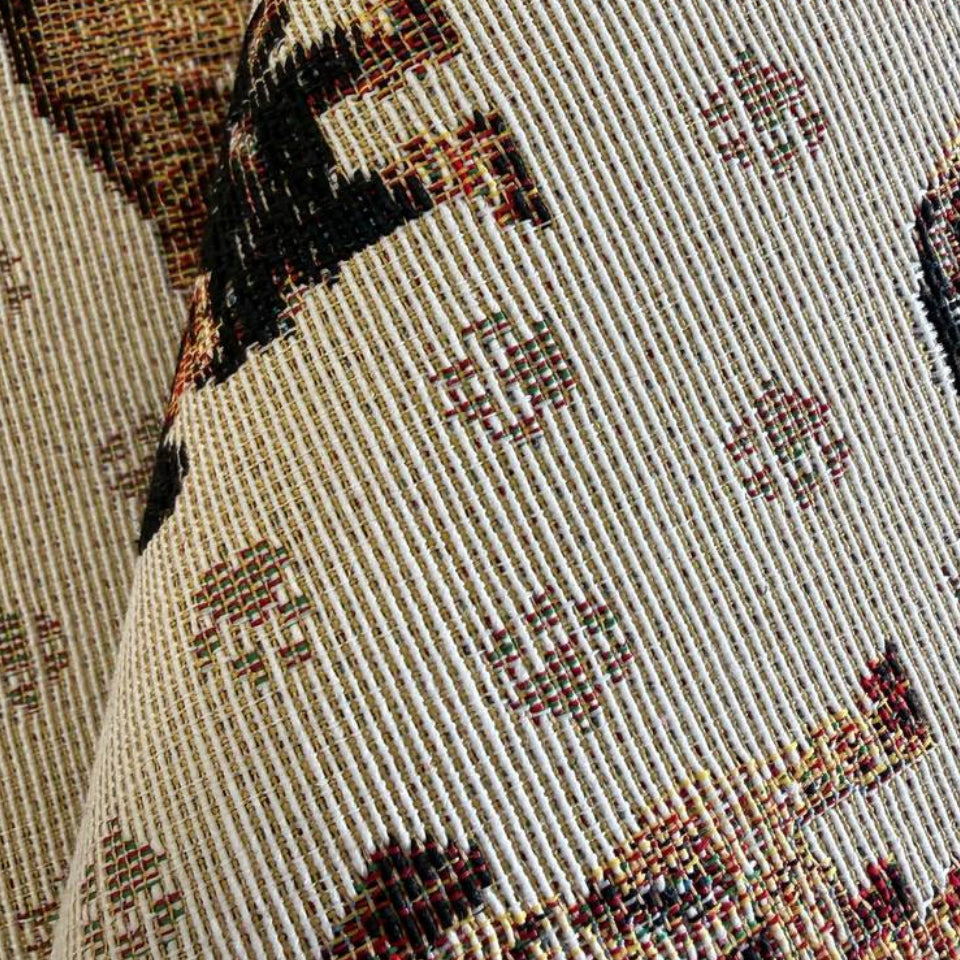 Decorative tapestry upholstery fabric featuring charming dog motifs on a soft beige background.