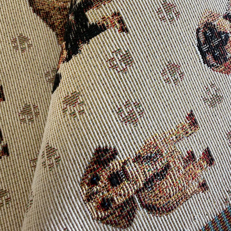Decorative tapestry upholstery fabric featuring charming dog motifs on a soft beige background.