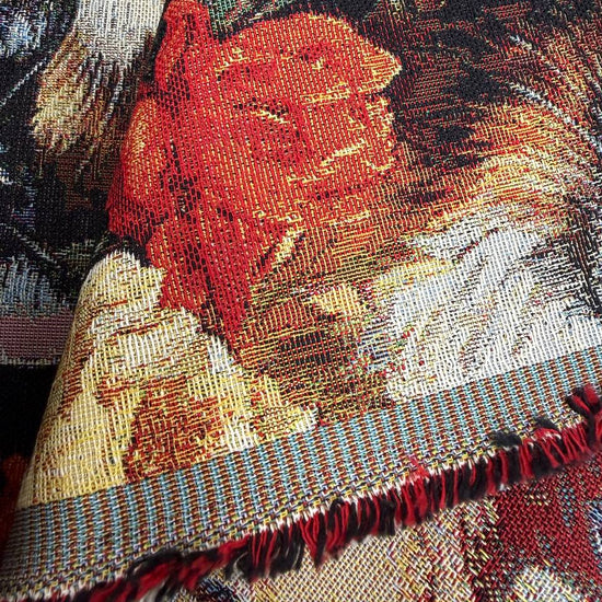 Beautiful tapestry home décor fabric featuring playful cats surrounded by vibrant orange and cream flowers on a dark background.