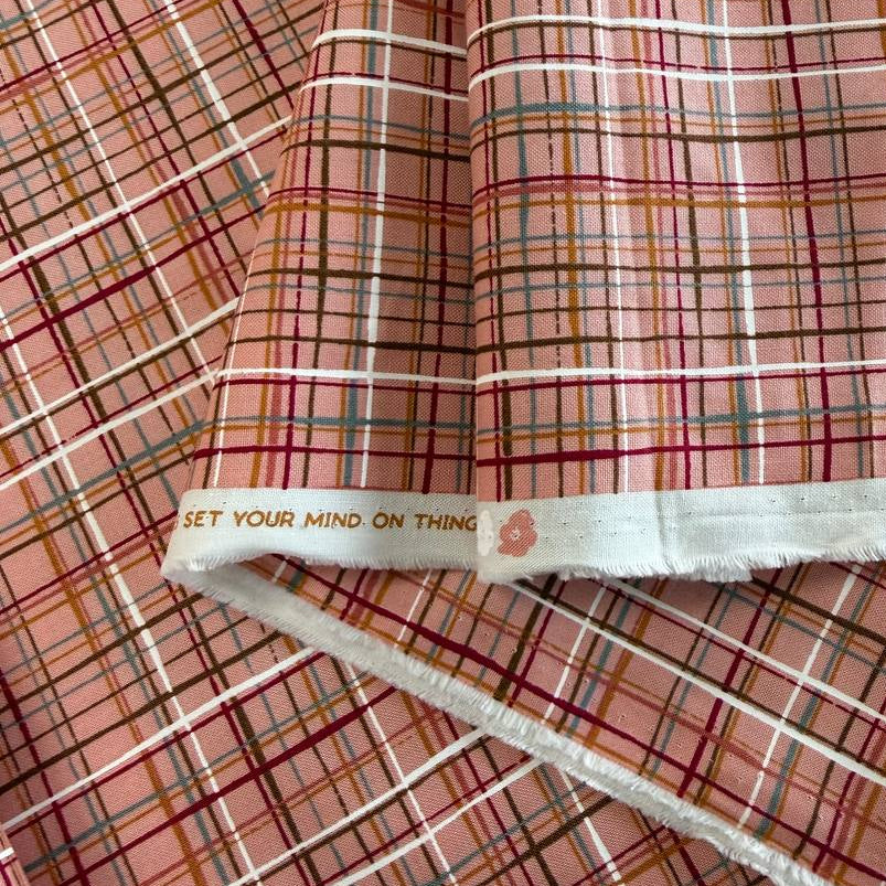 Pink quilting cotton featuring an intricate woven line plaid design in blush, burgundy, grey, gold, and white from the Things Above collection by Moda Fabrics.