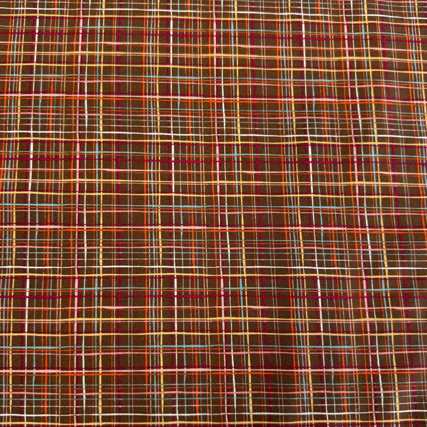 Brown quilting cotton featuring an intricate woven line plaid design in cocoa, orange, pink, blue, gold, and cream from the Things Above collection by Moda Fabrics.