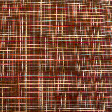 Brown quilting cotton featuring an intricate woven line plaid design in cocoa, orange, pink, blue, gold, and cream from the Things Above collection by Moda Fabrics.