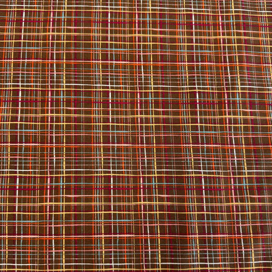 Brown quilting cotton featuring an intricate woven line plaid design in cocoa, orange, pink, blue, gold, and cream from the Things Above collection by Moda Fabrics.