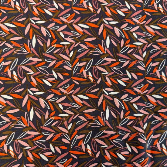 Modern quilting cotton fabric featuring an all-over scattered leaf print in blush pink, orange, cream, and olive tones on a charcoal grey background from the Things Above collection by Fancy That Design House for Moda Fabrics.