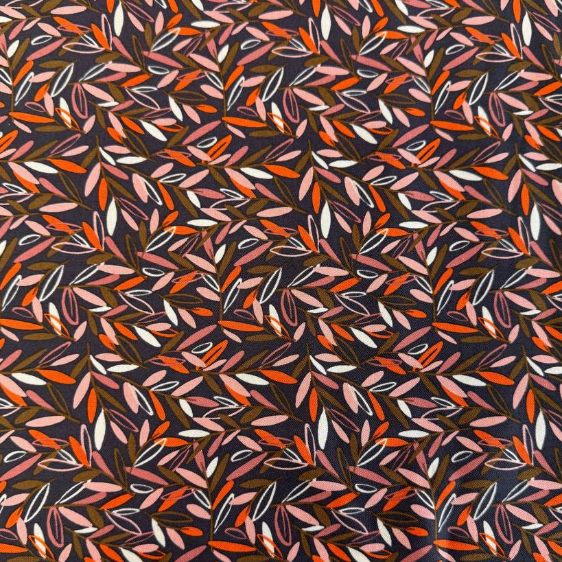 Modern quilting cotton fabric featuring an all-over scattered leaf print in blush pink, orange, cream, and olive tones on a charcoal grey background from the Things Above collection by Fancy That Design House for Moda Fabrics.