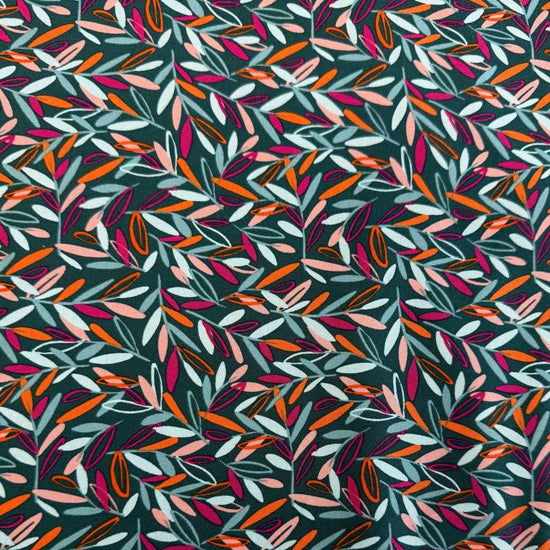 Modern quilting cotton fabric featuring an all-over scattered leaf print in teal, blush pink, orange, aqua, and magenta tones on a deep teal background from the Things Above collection by Fancy That Design House for Moda Fabrics.