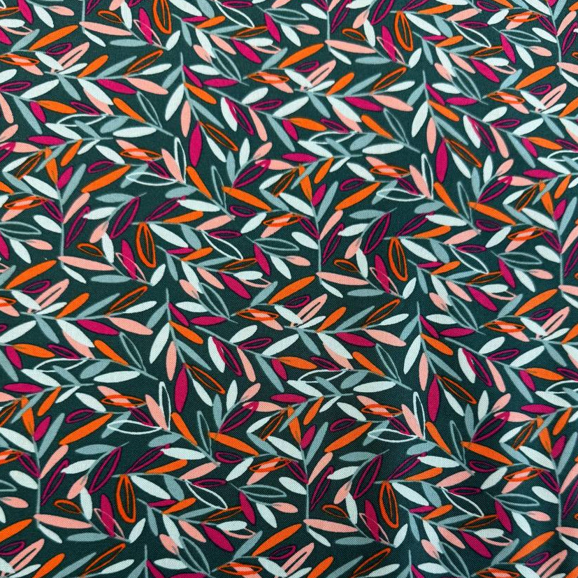 Modern quilting cotton fabric featuring an all-over scattered leaf print in teal, blush pink, orange, aqua, and magenta tones on a deep teal background from the Things Above collection by Fancy That Design House for Moda Fabrics.