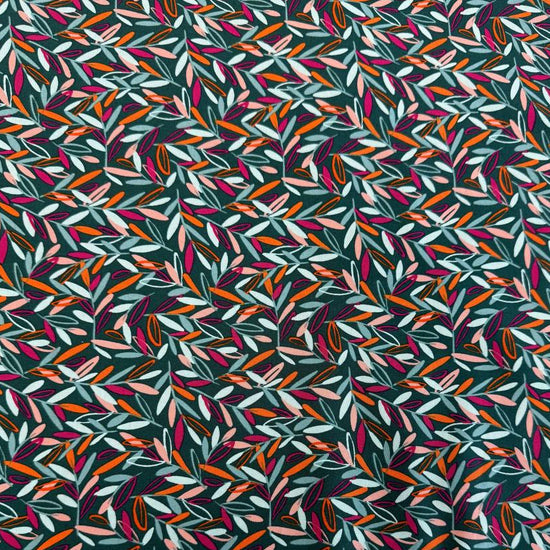 Modern quilting cotton fabric featuring an all-over scattered leaf print in teal, blush pink, orange, aqua, and magenta tones on a deep teal background from the Things Above collection by Fancy That Design House for Moda Fabrics.