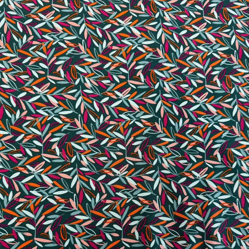 Modern quilting cotton fabric featuring an all-over scattered leaf print in teal, blush pink, orange, aqua, and magenta tones on a deep teal background from the Things Above collection by Fancy That Design House for Moda Fabrics.
