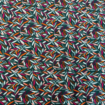 Modern quilting cotton fabric featuring an all-over scattered leaf print in teal, blush pink, orange, aqua, and magenta tones on a deep teal background from the Things Above collection by Fancy That Design House for Moda Fabrics.
