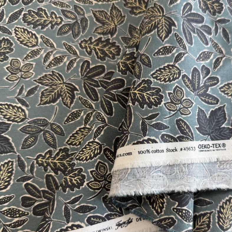 Blue grey quilting cotton featuring an allover leaf print from Moda Fabrics' Foraged, Found & Hand Me Down collection.