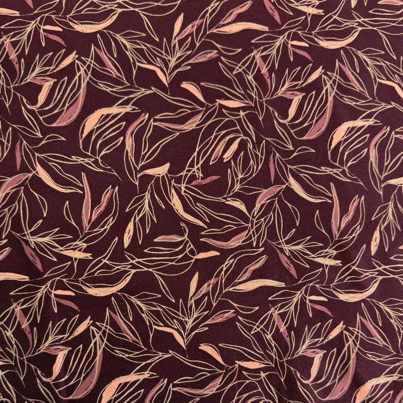 Deep plum quilting cotton featuring delicate scattered leaf silhouettes in mauve and blush tones from the Foraged, Found & Hand Me Down collection by Fancy That Design House for Moda Fabrics.