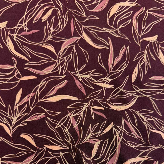 Deep plum quilting cotton featuring delicate scattered leaf silhouettes in mauve and blush tones from the Foraged, Found & Hand Me Down collection by Fancy That Design House for Moda Fabrics.