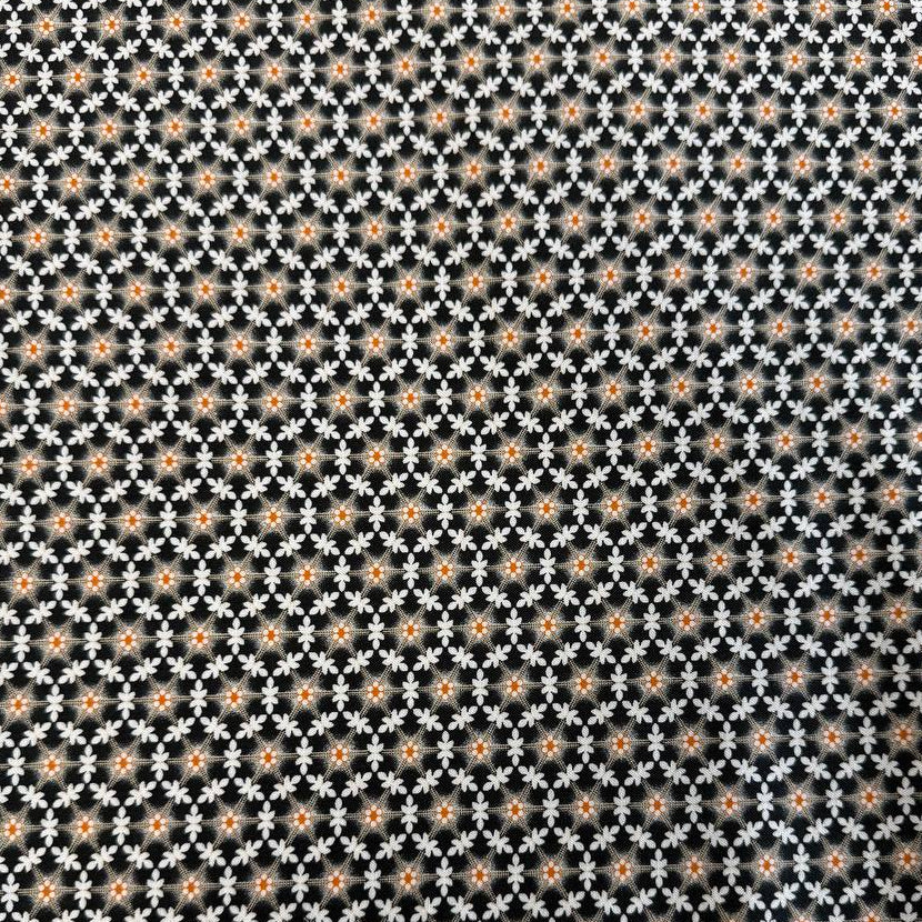 Small white floral lattice print with orange flower centers on a deep midnight background from Agatha Road by Fig Tree & Co. for Moda.