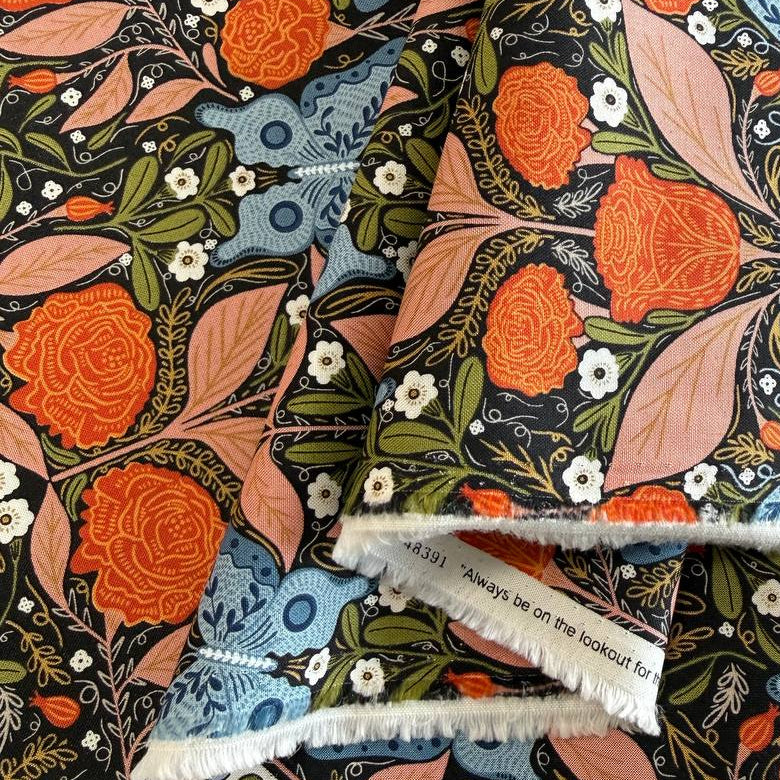 Woodland Wonder Midnight quilting cotton featuring blue butterflies, orange roses, pink leaves, and botanical motifs on a black background by Gingiber for Moda Fabrics.