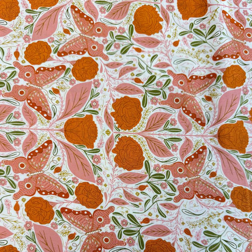Woodland Wonder quilting cotton featuring pink butterflies, orange roses, soft pink leaves, and botanical motifs on a light cream background.