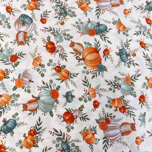 Autumn-themed quilting cotton featuring watercolor pumpkins, woodland elements, green foliage, and harvest florals on a light cream background from the I Love Fall Most Of All collection by Deb Strain for Moda Fabrics.