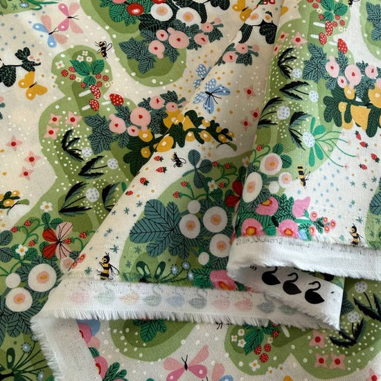 Love Letter Eggshell quilting cotton by Lizzy House for Moda Fabrics featuring colorful flowers, bees, dragonflies, berries, and greenery on a soft cream background.