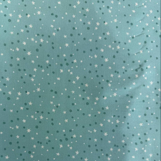 Blue quilting cotton featuring tiny white stars and scattered dots from the Blast Off collection by Stacy Iest Hsu for Moda Fabrics.