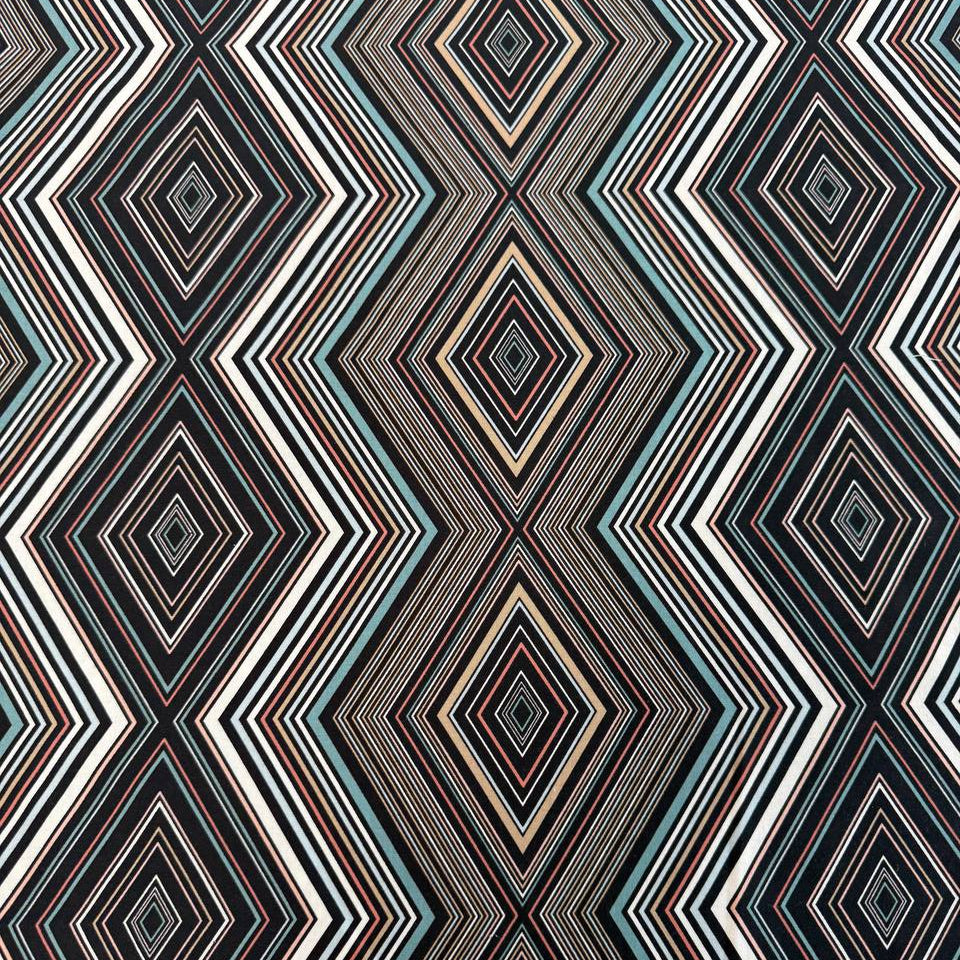 Nightlife geometric quilting fabric by Studio M for Moda Fabrics featuring layered diamond patterns in black, teal, cream, blush, coral, and gold tones.