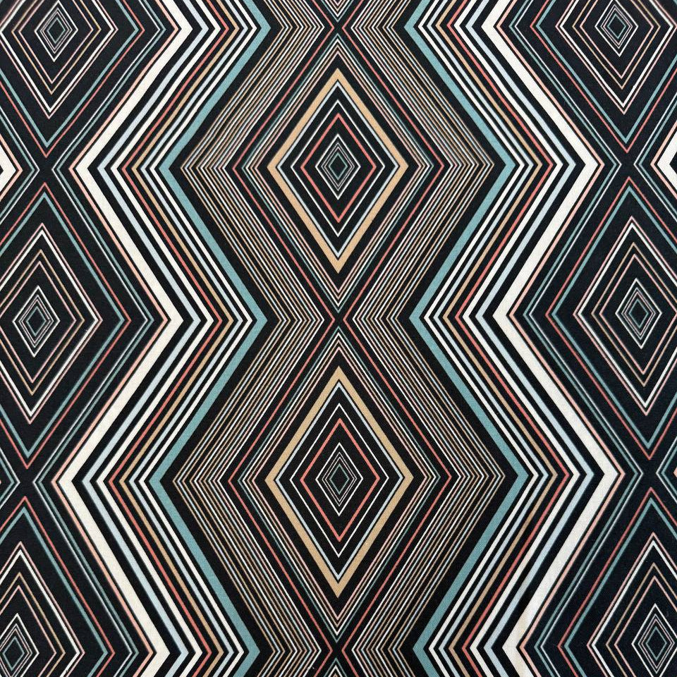 Nightlife geometric quilting fabric by Studio M for Moda Fabrics featuring layered diamond patterns in black, teal, cream, blush, coral, and gold tones.