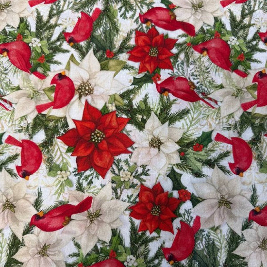 Christmas cotton fabric featuring red cardinals, white and red poinsettias, evergreen branches, and holiday greenery on a white background.