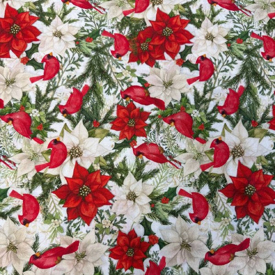 Christmas cotton fabric featuring red cardinals, white and red poinsettias, evergreen branches, and holiday greenery on a white background.