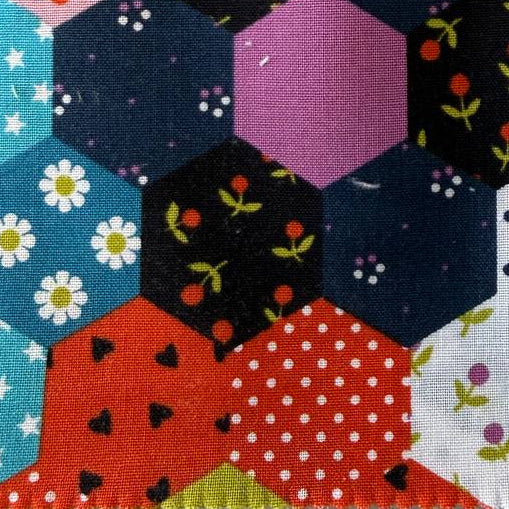 Colorful fabric swatch book with patterned cover on a white background