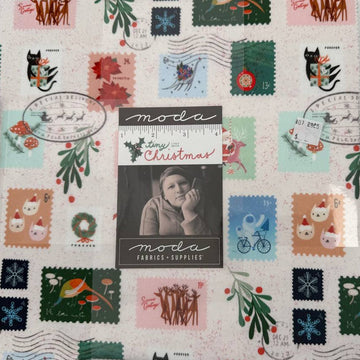 Tiny Christmas Layer Cake quilting fabric bundle by Moda Fabrics with Christmas postage stamp prints on cream background