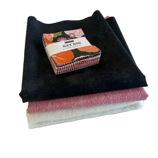 Mini Charm Hey Boo Table Runner Kit including Halloween-themed mini charm pack, coordinating black and pink fabrics, and batting for a festive quilted table runner.