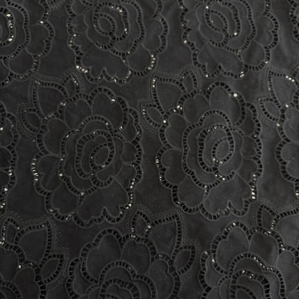 Black cut out lace fabric with floral eyelet pattern