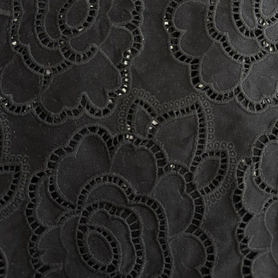 Black cut out lace fabric with floral eyelet pattern