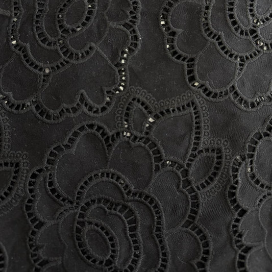 Black cut out lace fabric with floral eyelet pattern