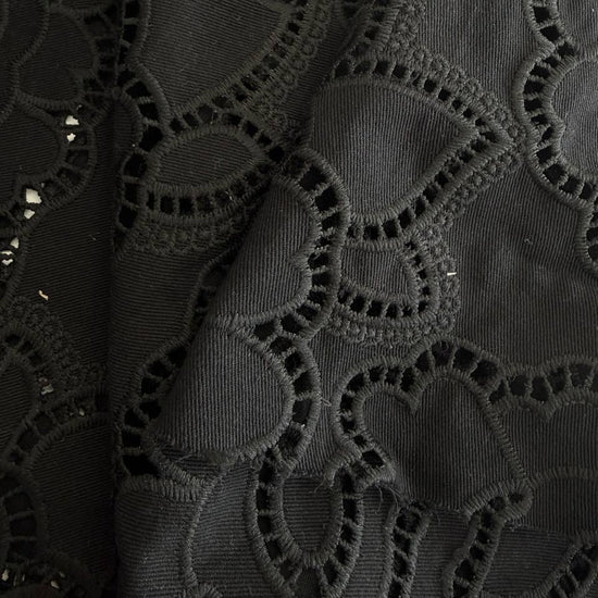 Black cut out lace fabric with floral eyelet pattern