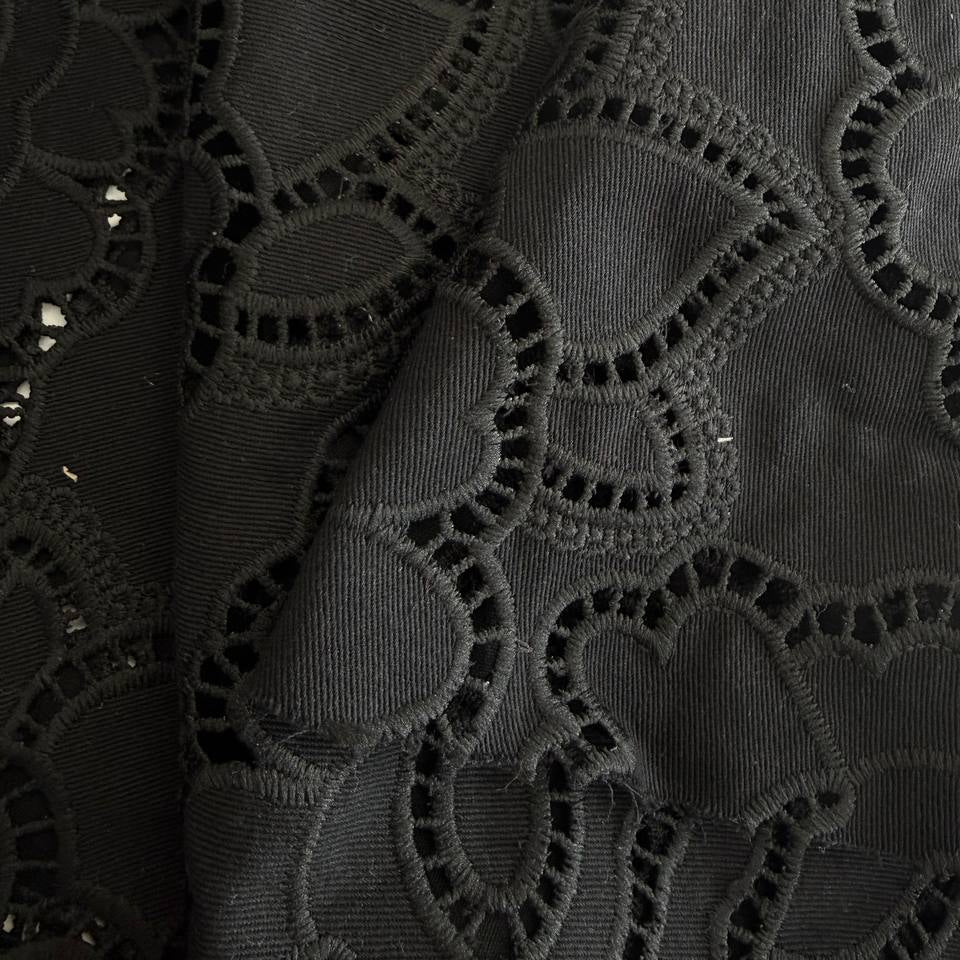 Black cut out lace fabric with floral eyelet pattern