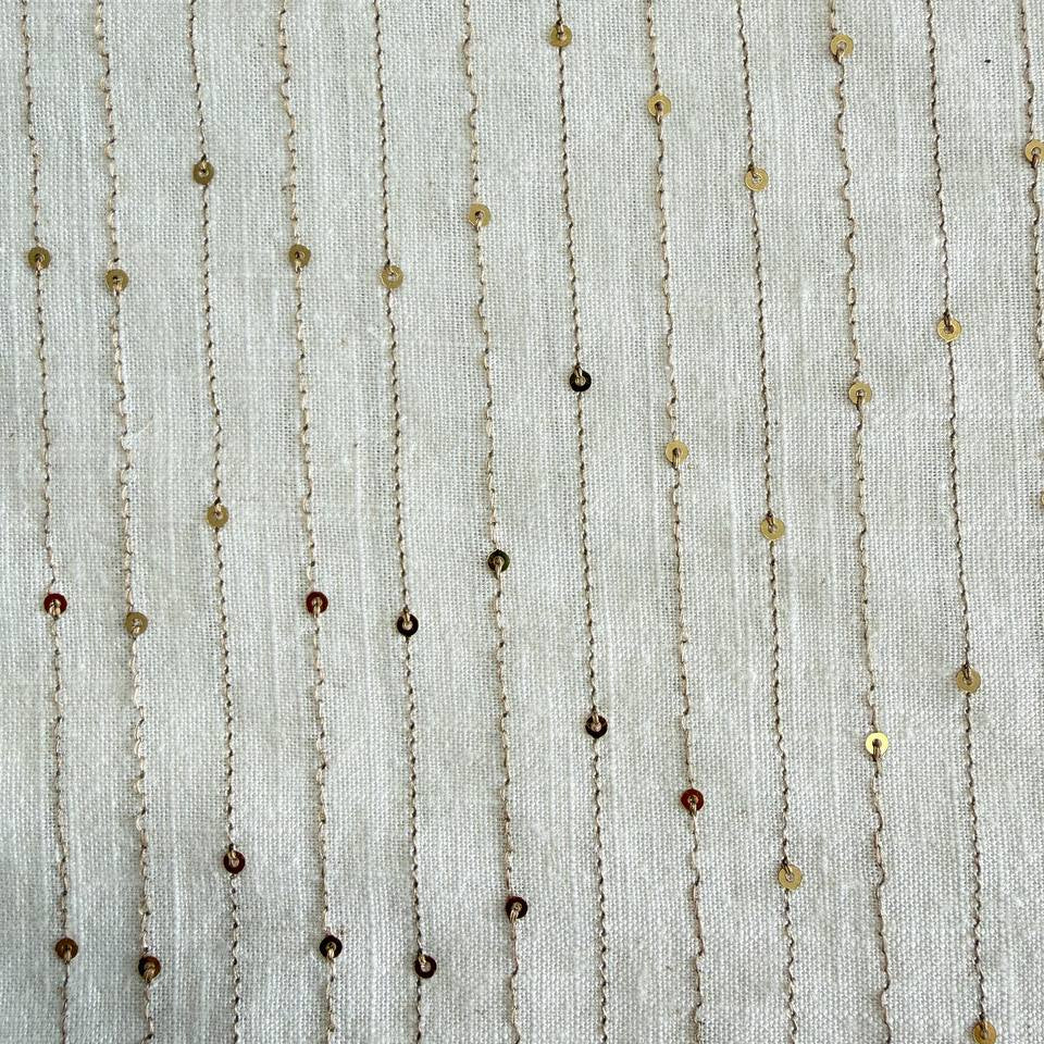 White linen blend fabric with vertical gold sequin lines