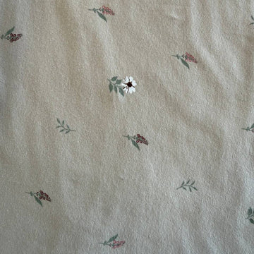 Beige cotton jersey fabric with small scattered floral print