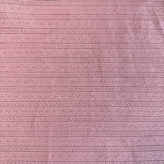 Dusty pink cotton pointelle knit fabric with delicate textured pattern