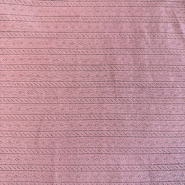 Dusty pink cotton pointelle knit fabric with delicate textured pattern
