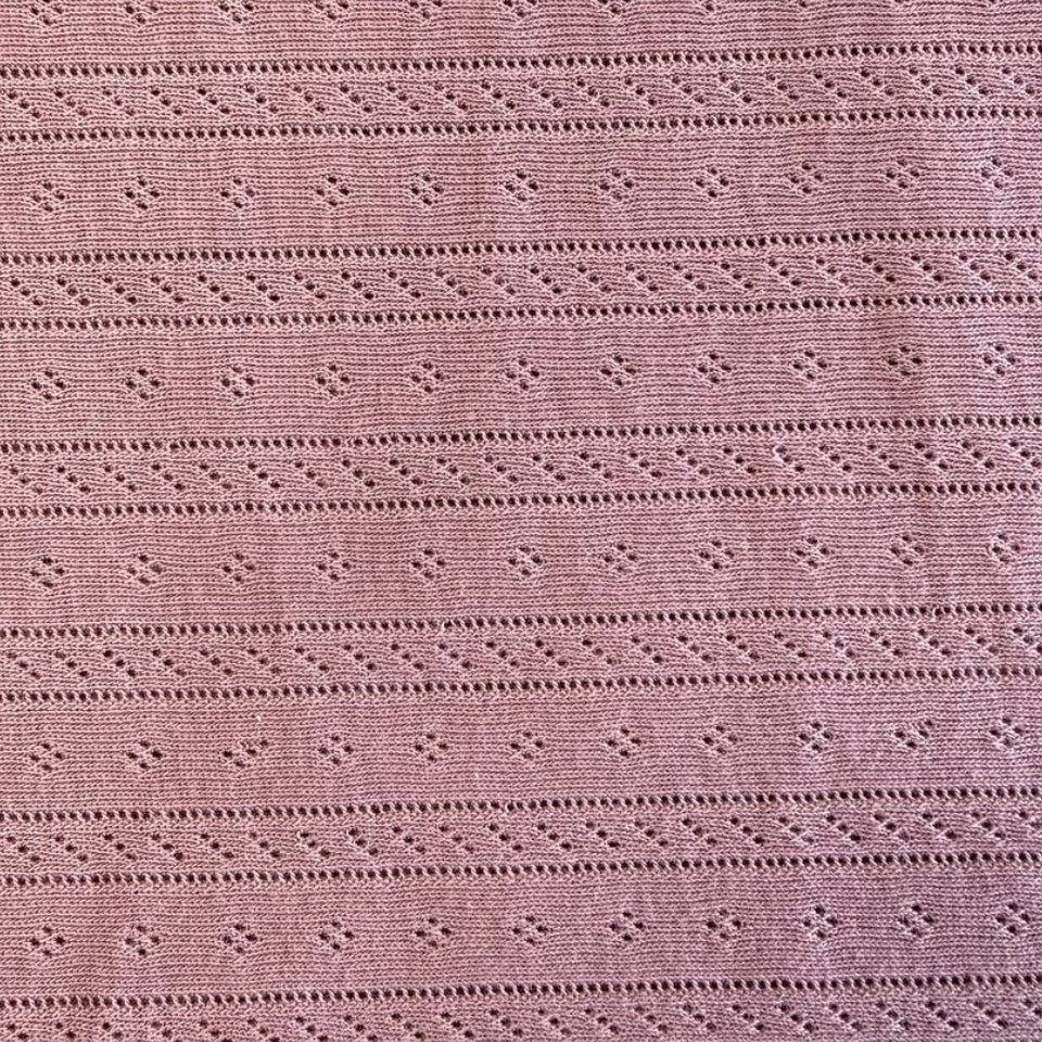 Dusty pink cotton pointelle knit fabric with delicate textured pattern