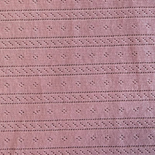 Dusty pink cotton pointelle knit fabric with delicate textured pattern
