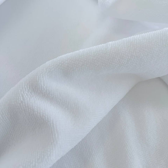 Soft white bamboo terry fabric texture close-up plush absorbent surface