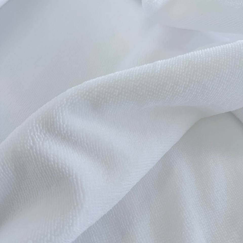Soft white bamboo terry fabric texture close-up plush absorbent surface