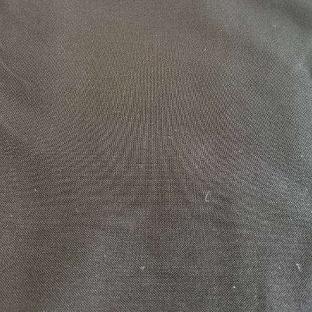 Black heavy cotton canvas fabric close-up texture, durable thick woven material for bags and upholstery