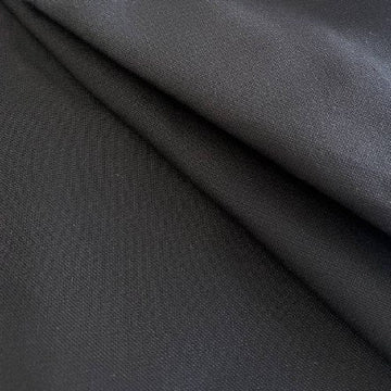 Black heavy cotton canvas fabric close-up texture, durable thick woven material for bags and upholstery