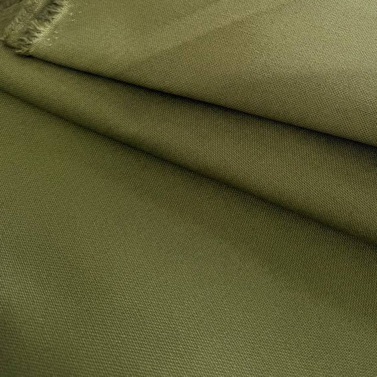 Heavy khaki cotton canvas fabric folded, textured durable material