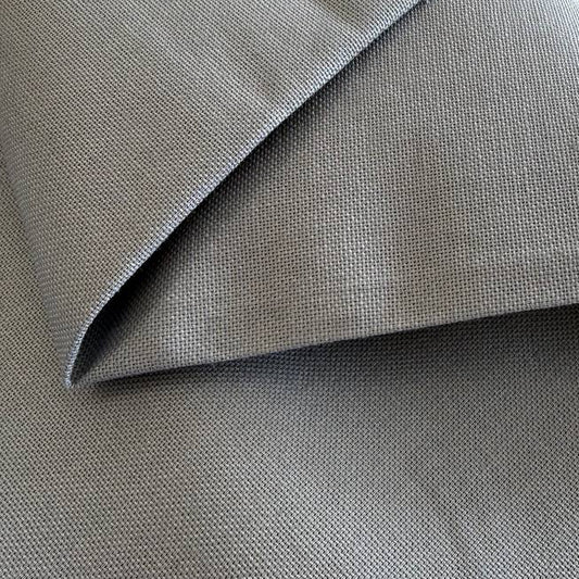 Heavy steel grey canvas fabric roll with visible texture