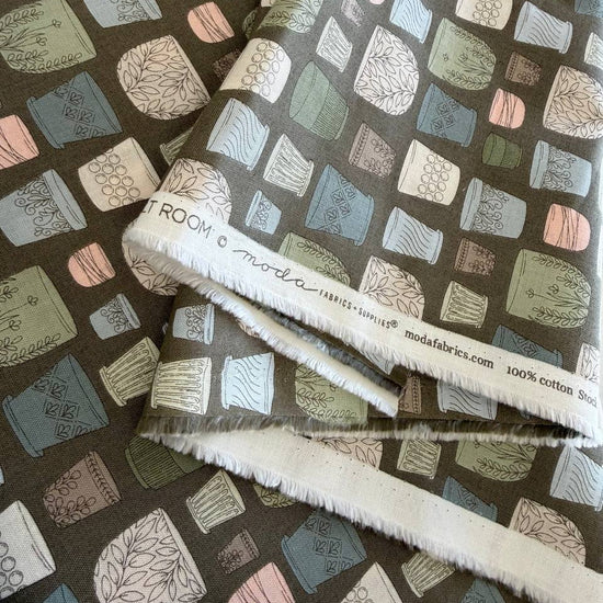 Cotton fabric with potted plants print in pastel colors on olive green background by Moda